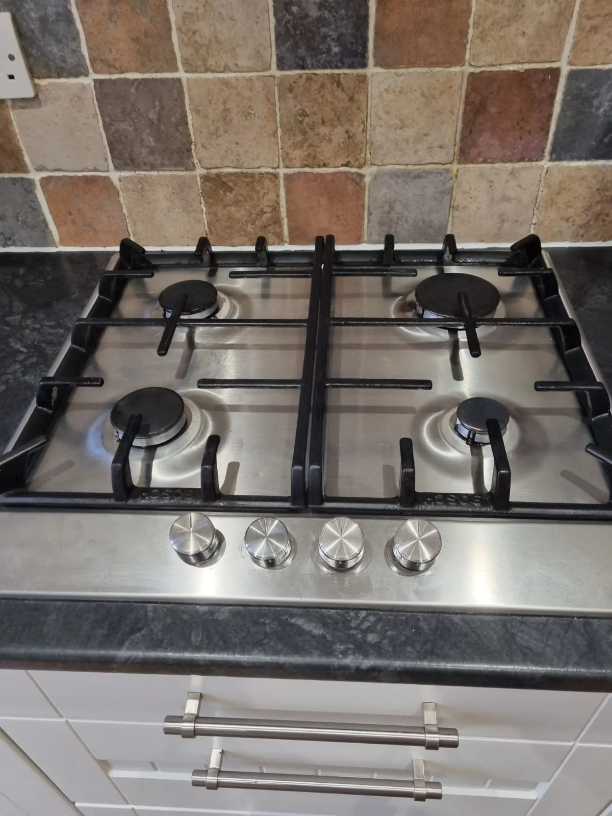 Polished stainless steel gas hob after an oven and hob clean