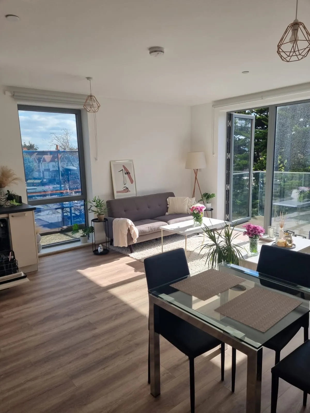 Bright living room with sofa and dining table after a clean
