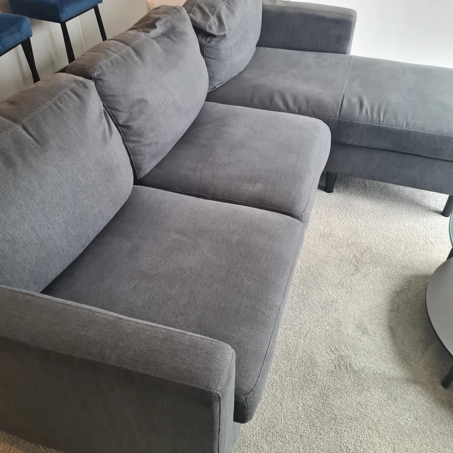 Grey corner sofa on clean carpet after upholstery cleaning